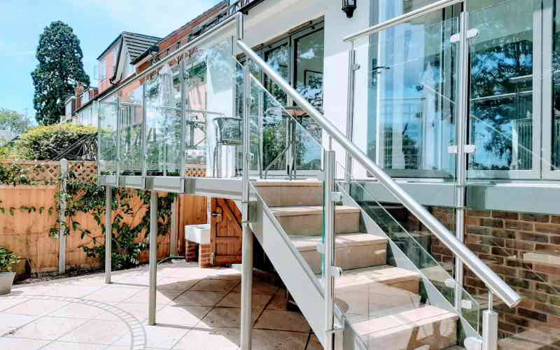 Side mounted stainless steel railings with glass and top rail