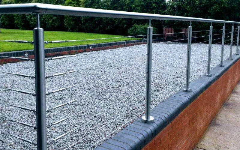 Wall top tension wire railing