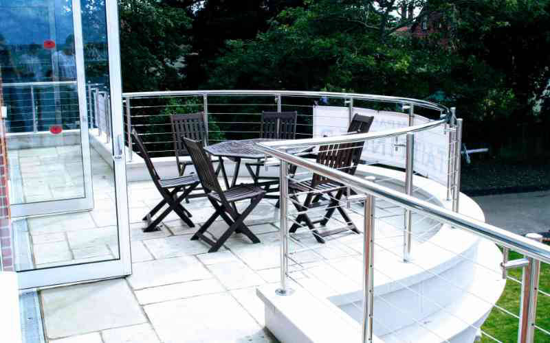 Stainless railing balustrade with curved top rail and tension wires
